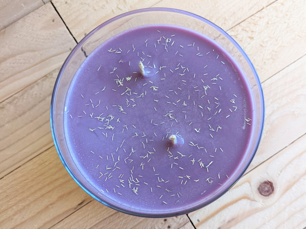 Close-up of purple Christmas Fantasy scented soy candle by A Glowing Trend showing glitter.