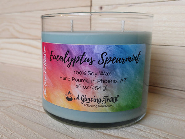 A 16 oz glass square containing a light green Eucalyptus Spearmint scented soy candle by A Glowing Trend