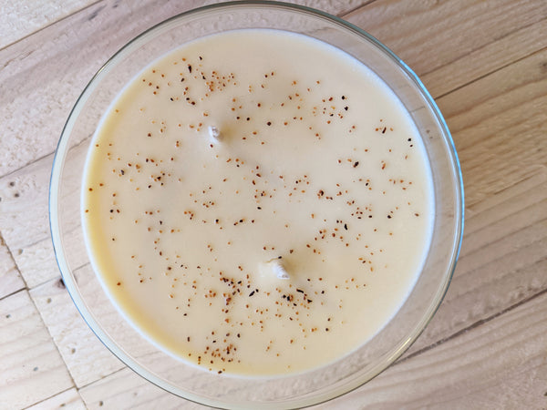 Close-up of light yellow Grandma's Eggnog scented soy candle by A Glowing Trend showing nutmeg.