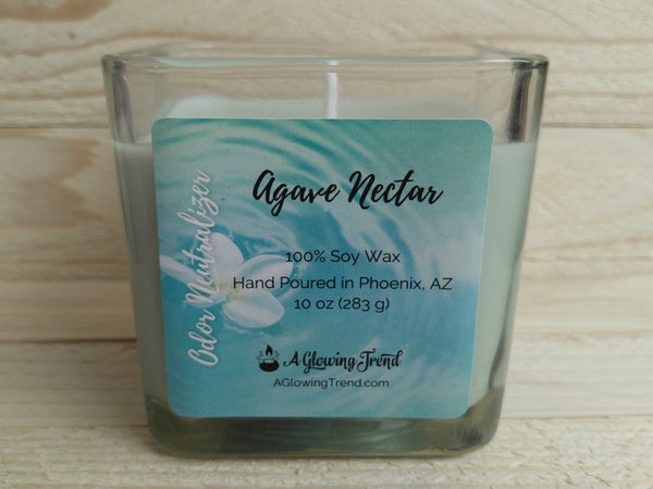 A 10 oz glass square containing a light green Odor Neutralizing Agave Nectar scented soy candle by A Glowing Trend.