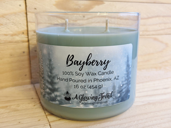 A 16 oz glass tumbler containing a green Bayberrry scented soy candle by A Glowing Trend