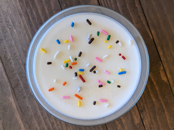 Close-up of white Birthday Cake scented soy candle by A Glowing Trend showing sugar sprinkles.
