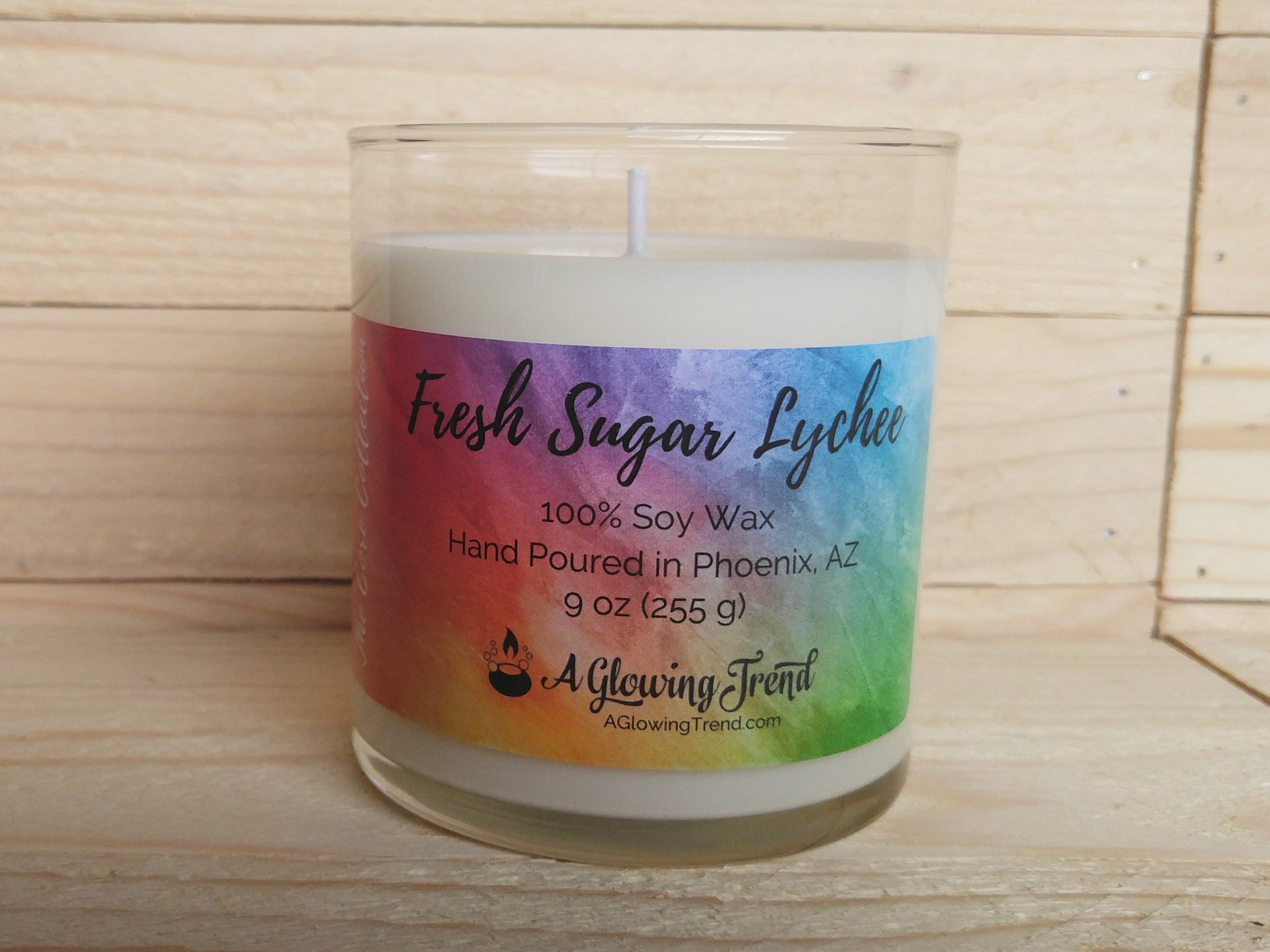 A 9 oz glass tumbler containing a white Fresh Sugar Lychee scented soy candle by A Glowing Trend