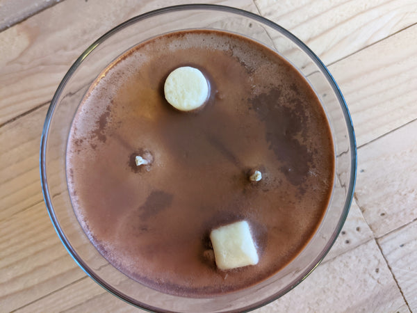 Close-up of brown Hot Cocoa scented soy candle by A Glowing Trend showing wax marshmallows.