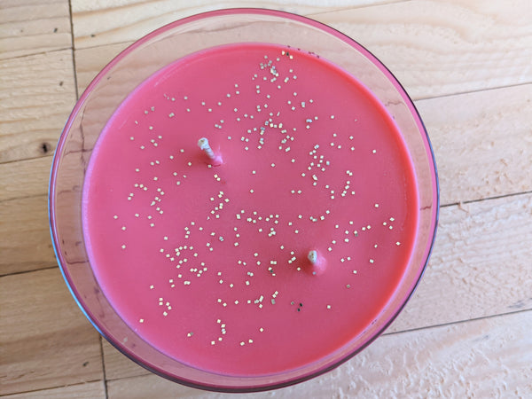 Close-up of red Icy Peppermint scented soy candle by A Glowing Trend showing glitter..