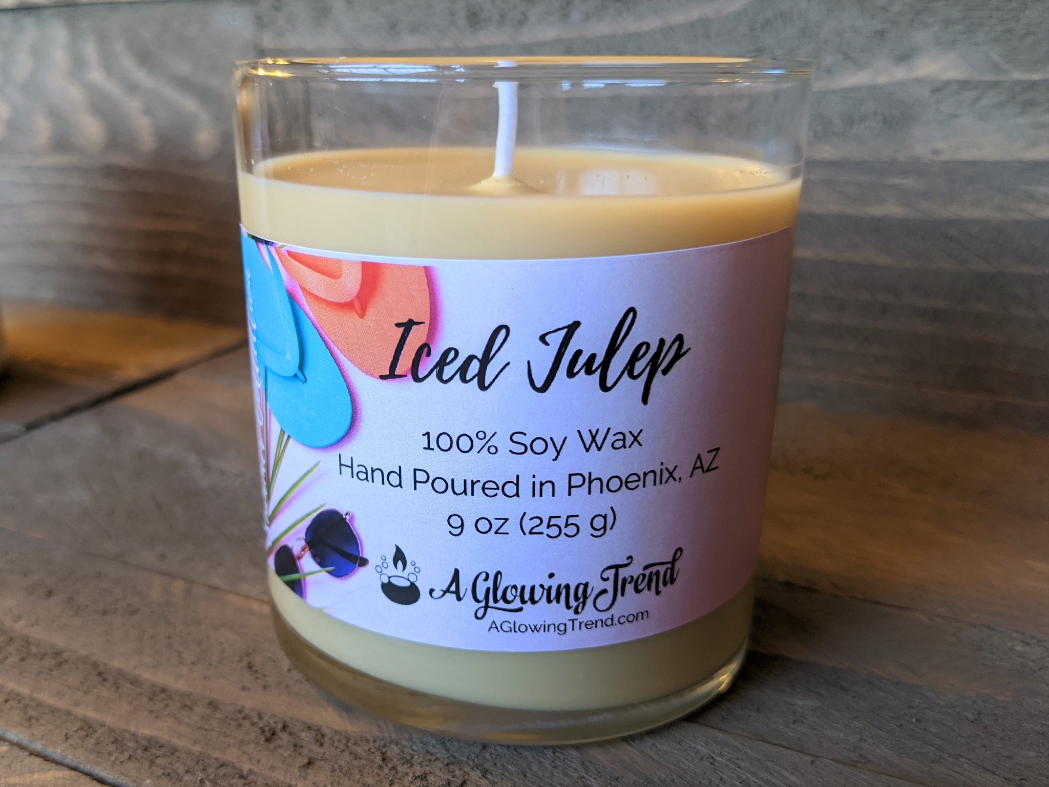 A 9 oz glass tumbler containing a light brown Iced Julep scented soy candle by A Glowing Trend.