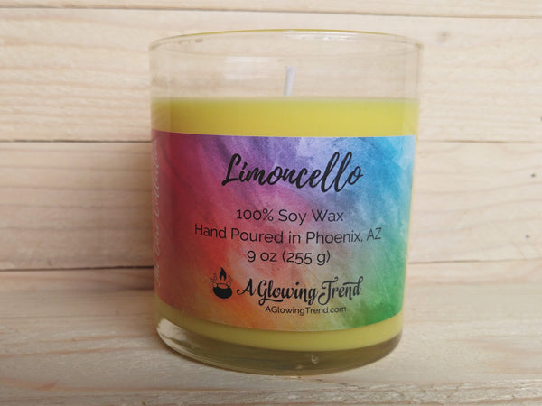 A 9 oz glass tumbler containing a yellow Limoncello scented soy candle by A Glowing Trend