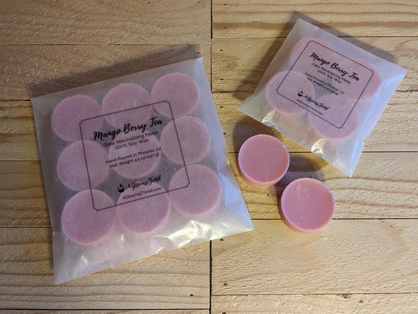 Selection of light pink odor neutralizing Mango Berry Tea fragranced wax tart melts.
