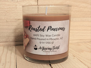 A 9 oz round glass tumbler containing a brown Roasted Pinecones scented soy candle by A Glowing Trend.