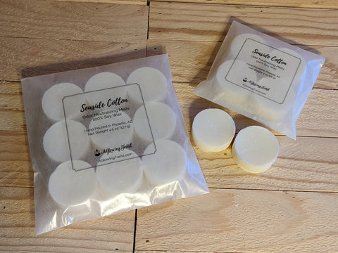 Selection of white odor neutralizing Seaside Cotton fragranced wax tart melts.