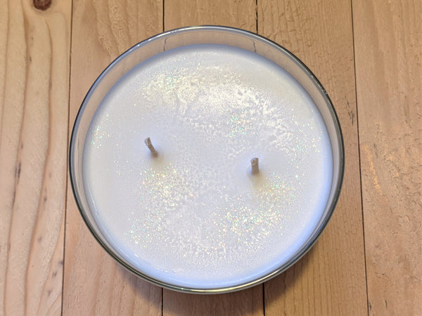 Close-up of white Snow Witch scented soy candle by A Glowing Trend showing glitter.