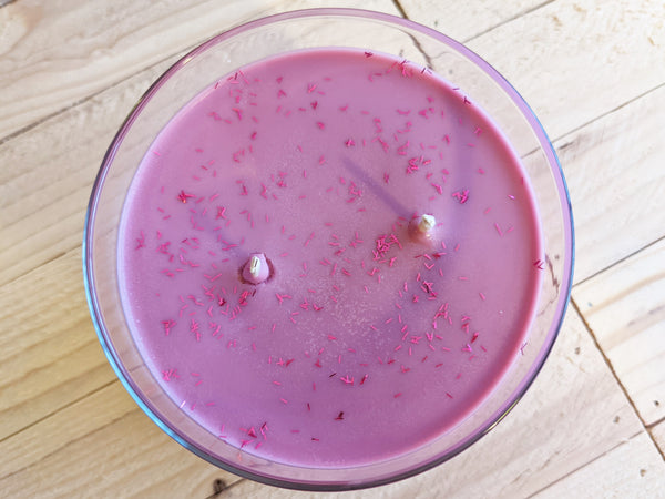Close-up of purple Spiced Cranberry scented soy candle by A Glowing Trend showing glitter.