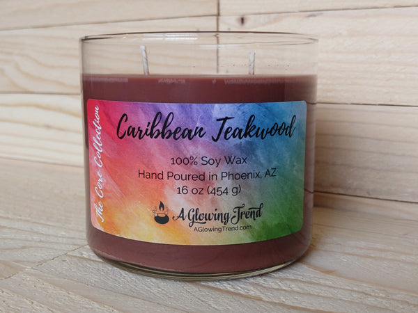A 16 oz glass tumbler containing a brown Caribbean Teakwood scented soy candle by A Glowing Trend