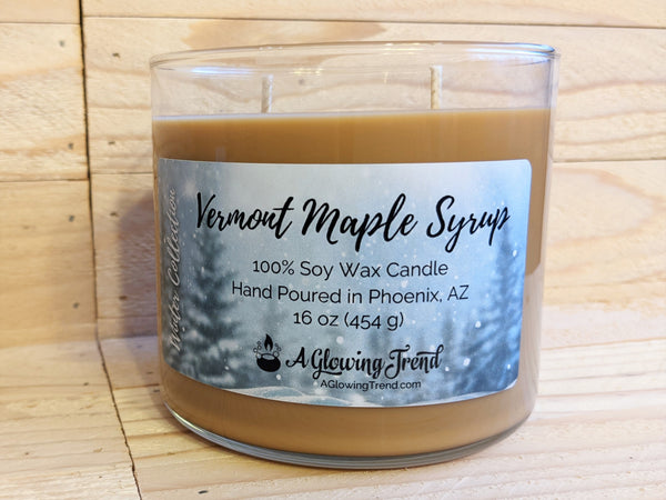 A 16 oz glass tumbler containing a brown Vermont Maple Syrup scented soy candle by A Glowing Trend