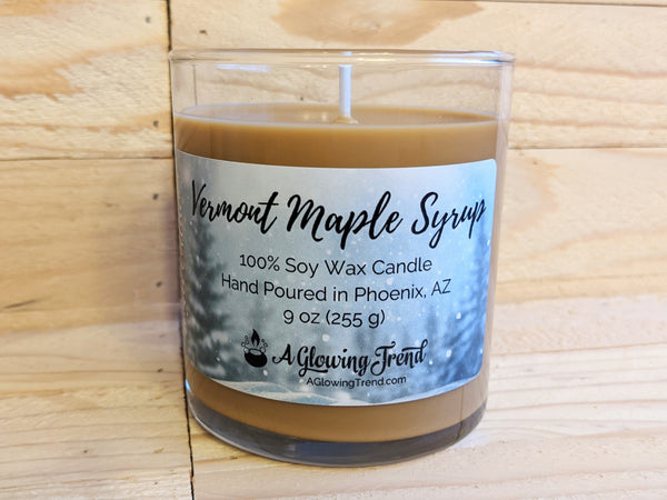 A 9 oz glass tumbler containing a brown Vermont Maple Syrup scented soy candle by A Glowing Trend